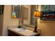 Bathroom with an elegant mirror, a lamp and a beautiful painting on the wall at 805 Hemlock Dr, Apopka, FL 32712