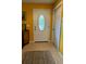 Inviting foyer with decorative front door and warm yellow walls at 805 Hemlock Dr, Apopka, FL 32712