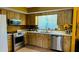 Traditional kitchen design featuring wood cabinets and modern stainless steel appliances at 805 Hemlock Dr, Apopka, FL 32712