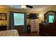 Relaxing main bedroom with hardwood floors, a ceiling fan and a large window for natural light at 805 Hemlock Dr, Apopka, FL 32712