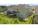 Expansive backyard featuring a screened porch, deck, and lush green lawn with a view of the community pool at 8724 Peachtree Park Ct, Windermere, FL 34786