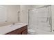 Well-lit bathroom with a vanity, toilet, and tub-shower combo enclosed by a glass door at 8724 Peachtree Park Ct, Windermere, FL 34786