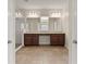 Spacious bathroom with double sink vanity, cabinets, and large mirror, plus walk-in shower at 8724 Peachtree Park Ct, Windermere, FL 34786