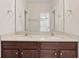 Modern bathroom featuring a double vanity with quartz counters and dark wood cabinets at 8724 Peachtree Park Ct, Windermere, FL 34786