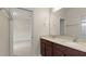 This bathroom features a double vanity with dark wood cabinets and a large mirror at 8724 Peachtree Park Ct, Windermere, FL 34786