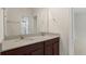 Bathroom with double vanity, a large mirror, and good lighting, leading to another room at 8724 Peachtree Park Ct, Windermere, FL 34786