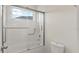 This bathroom features a tub and shower combo with glass doors, and a toilet at 8724 Peachtree Park Ct, Windermere, FL 34786