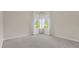 This bedroom has two large windows letting in lots of natural light and neutral carpeting at 8724 Peachtree Park Ct, Windermere, FL 34786
