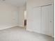 Spacious carpeted bedroom with double closets and an adjoining bathroom at 8724 Peachtree Park Ct, Windermere, FL 34786