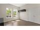 Bright bedroom with hardwood floors and a simple black cabinet at 8724 Peachtree Park Ct, Windermere, FL 34786