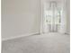 Carpeted bedroom with two large windows dressed with white curtains allowing ample natural light at 8724 Peachtree Park Ct, Windermere, FL 34786