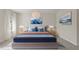 Bright bedroom features a queen bed with stylish blue and orange accents, plus matching nightstands at 8724 Peachtree Park Ct, Windermere, FL 34786