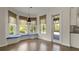 Bright dining area with hardwood floors, large windows, and a cozy window seat at 8724 Peachtree Park Ct, Windermere, FL 34786