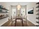 Bright dining room featuring wood floors, modern shelving, and a decorative chandelier at 8724 Peachtree Park Ct, Windermere, FL 34786