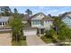 Charming home with a brick driveway, two-car garage, and lush landscaping at 8724 Peachtree Park Ct, Windermere, FL 34786