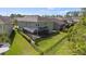 Aerial view of the back of the home with a screened-in patio and spacious backyard at 8724 Peachtree Park Ct, Windermere, FL 34786