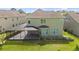 Aerial view of the home's exterior featuring a screened-in patio and well-maintained lawn at 8724 Peachtree Park Ct, Windermere, FL 34786