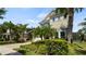 Attractive home showcasing a brick driveway and lush tropical landscaping at 8724 Peachtree Park Ct, Windermere, FL 34786