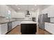Modern kitchen features stainless appliances, a large island, and white subway tile backsplash at 8724 Peachtree Park Ct, Windermere, FL 34786