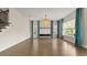 Bright, open living space with hardwood floors, large windows with blue curtains, and a staircase at 8724 Peachtree Park Ct, Windermere, FL 34786