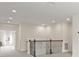 This open loft area features neutral carpeting and a wrought iron railing at 8724 Peachtree Park Ct, Windermere, FL 34786