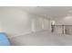 This open loft area features neutral carpeting and a wrought iron railing at 8724 Peachtree Park Ct, Windermere, FL 34786