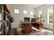 Bright office with a wooden desk, shelving, and natural light at 8724 Peachtree Park Ct, Windermere, FL 34786