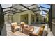 Inviting screened patio with stylish furniture, perfect for outdoor relaxation and entertaining at 8724 Peachtree Park Ct, Windermere, FL 34786