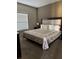 Comfortable bedroom with a plush bed, soft lighting, and window at 8981 Shine Dr, Kissimmee, FL 34747