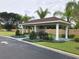 Community BBQ area with a covered shelter, a sink, an outdoor grill, and well-manicured landscaping at 8981 Shine Dr, Kissimmee, FL 34747