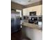 Well-equipped kitchen with granite countertops and stainless steel refrigerator at 8981 Shine Dr, Kissimmee, FL 34747