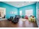 Spacious playroom with vibrant blue walls, foosball table, and fun ' furniture creates a welcoming space at 8981 Shine Dr, Kissimmee, FL 34747