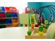 Close-up of a colorful wooden bead maze toy sitting on a table in a ' play area at 8981 Shine Dr, Kissimmee, FL 34747