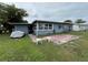View of the home's backyard featuring a patio and lawn at 921 Louisiana Ave, St Cloud, FL 34769