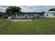 Exterior shot of the home's backyard, highlighting the patio area and surrounding green space at 921 Louisiana Ave, St Cloud, FL 34769