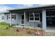 Close up of charming one-story home with covered entry and red shutters at 921 Louisiana Ave, St Cloud, FL 34769