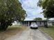 Charming one-story home with mature trees, a gray exterior, and a concrete driveway at 921 Louisiana Ave, St Cloud, FL 34769
