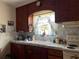 Kitchen with stainless steel sink, marble countertop, and wood cabinetry at 921 Louisiana Ave, St Cloud, FL 34769