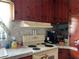 Kitchen with white appliances, marble countertop, and wood cabinetry at 921 Louisiana Ave, St Cloud, FL 34769