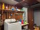 Functional laundry room with a modern washing machine, storage shelves, and convenient access to cleaning supplies at 921 Louisiana Ave, St Cloud, FL 34769