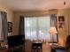 Cozy living room with natural light, a television, and comfortable furnishings at 921 Louisiana Ave, St Cloud, FL 34769