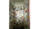 Shower showcasing vibrant multi-colored tiles and classic fixtures at 921 Louisiana Ave, St Cloud, FL 34769