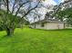 Expansive backyard featuring a lush lawn and mature trees at 12513 Indiana Woods Ln, Orlando, FL 32824