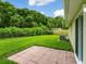 Private backyard featuring a patio and views of trees, providing a serene outdoor living space at 12513 Indiana Woods Ln, Orlando, FL 32824