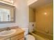 Retro-inspired bathroom featuring a vanity, toilet, and a tiled shower, offering a unique and functional design at 12513 Indiana Woods Ln, Orlando, FL 32824