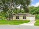 Charming single-story home featuring a well-manicured lawn and a mature tree in a desirable neighborhood at 12513 Indiana Woods Ln, Orlando, FL 32824