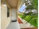 Inviting entryway featuring a white front door, well-manicured landscaping, and a charming outdoor light fixture at 12513 Indiana Woods Ln, Orlando, FL 32824