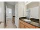 Bathroom with wood cabinets and black granite countertop at 12755 Westside Village Loop, Windermere, FL 34786