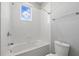 Bright bathroom featuring a tub, window, and white tile surround at 12755 Westside Village Loop, Windermere, FL 34786