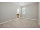 Bedroom features wood-look floors, a window, and a view into the attached bathroom at 12755 Westside Village Loop, Windermere, FL 34786